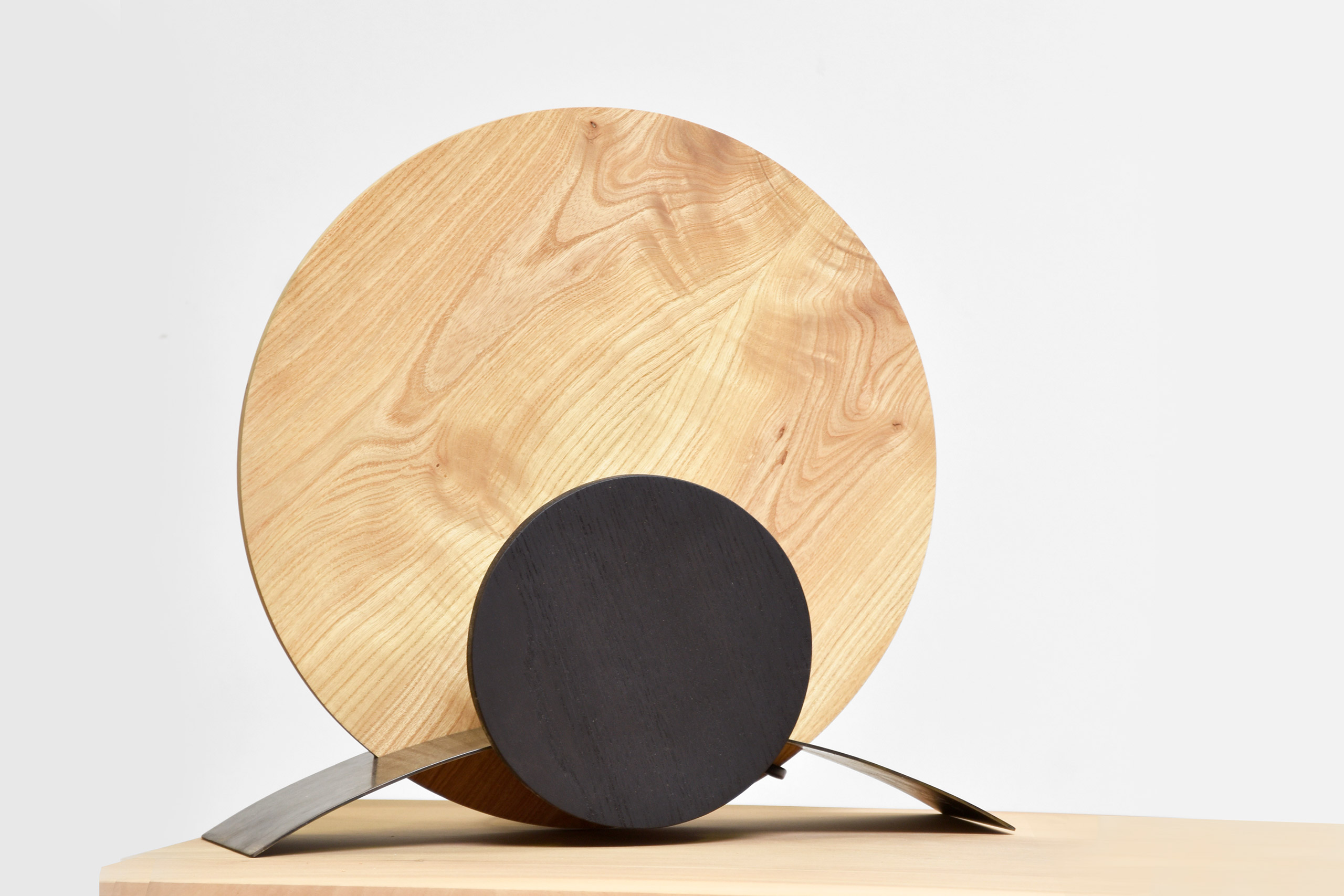 lampe ronde en bois claire et metal pose sur un meuble
